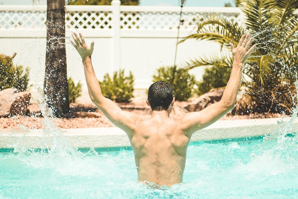 A man doing pool exercises in the summer.