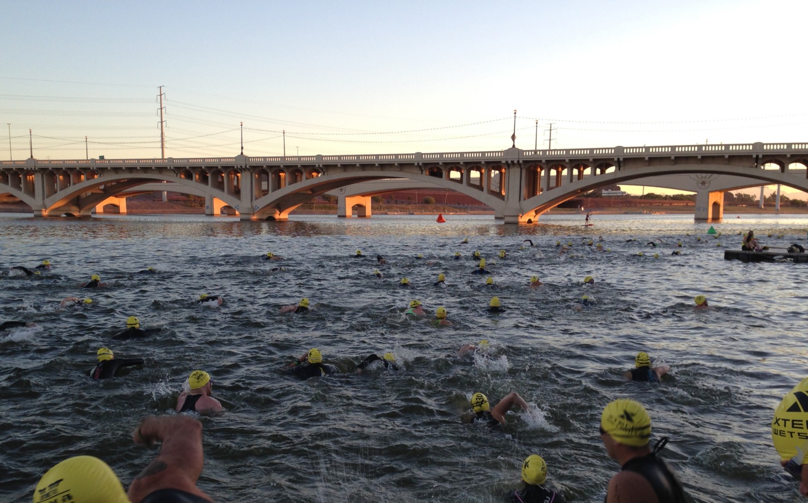 A group of swimmers racing in Tempe Town Lake in a marathon.