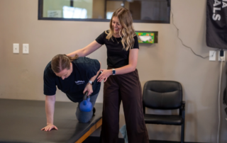 A physical therapist with a woman doing exercises.