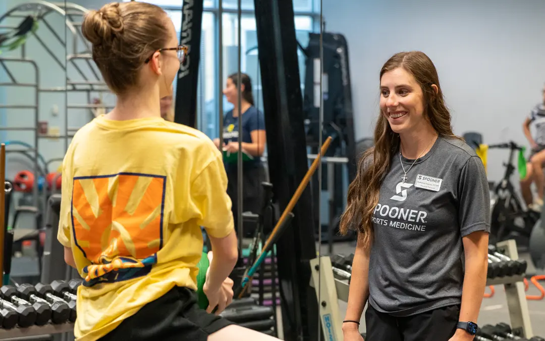 Feature Image of Mckenna working with a young athlete.