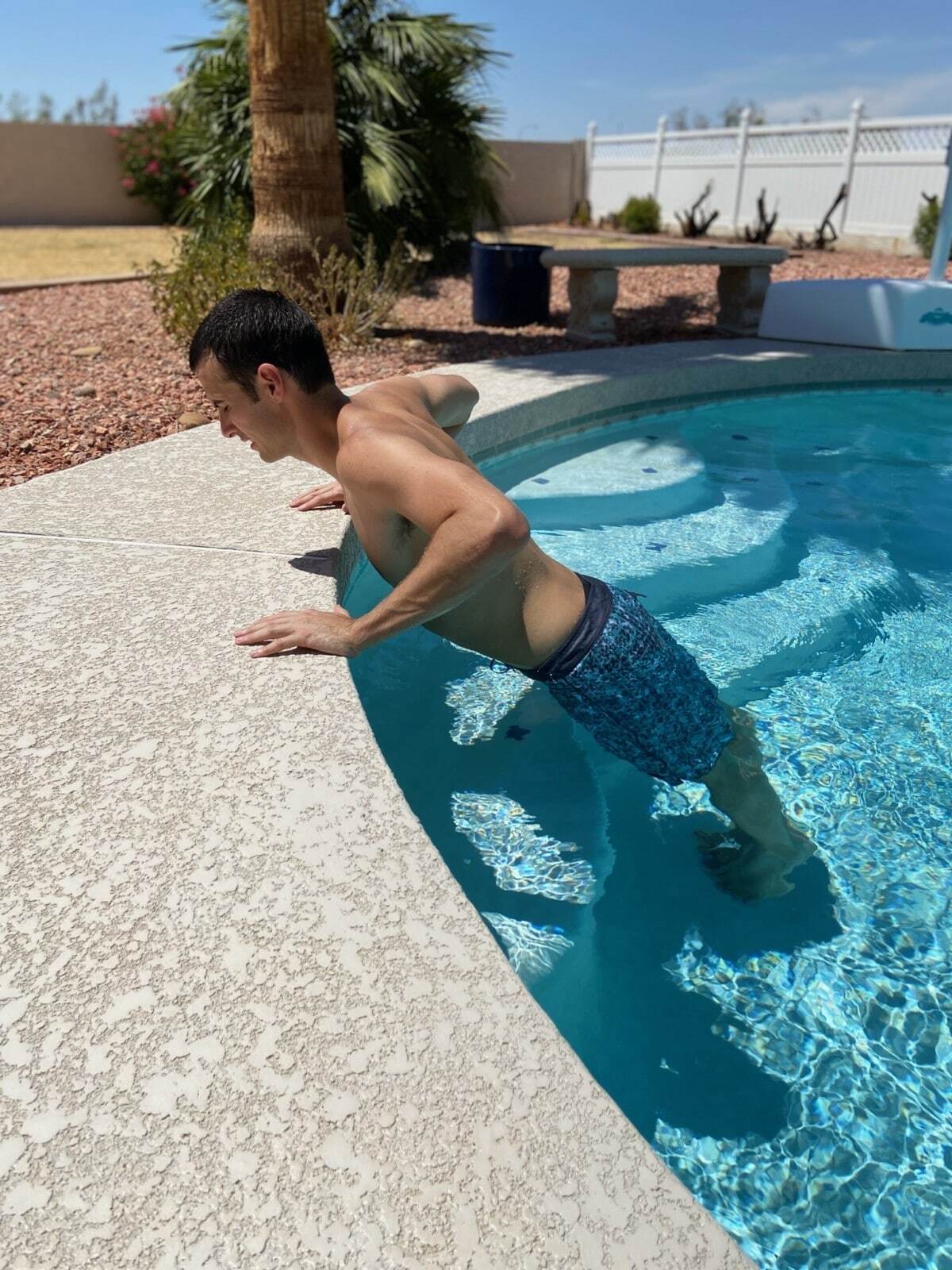 A man doing Pushups in a pool