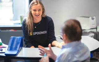 A hand therapist discussing the benefits of hand therapy treatment for trigger finger with a patient.