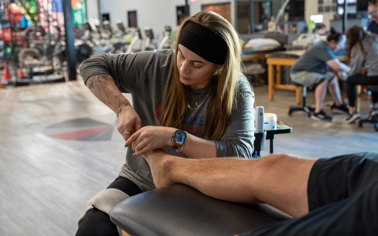A therapist working on the foot of a patient.
