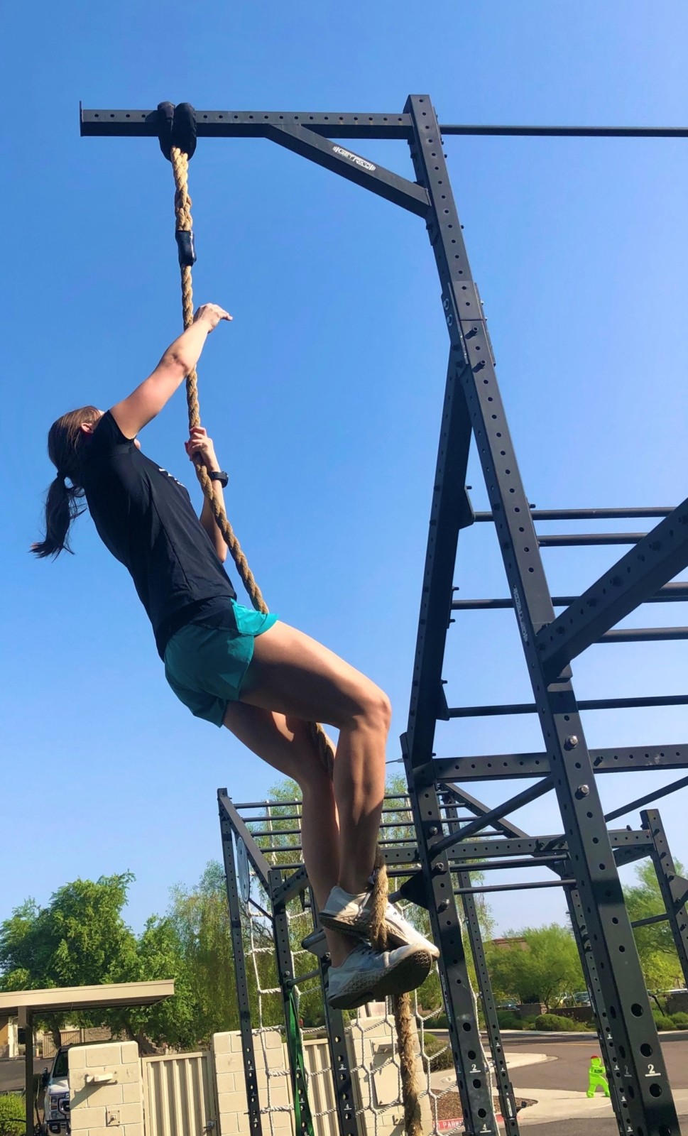 A woman climbing a rope.