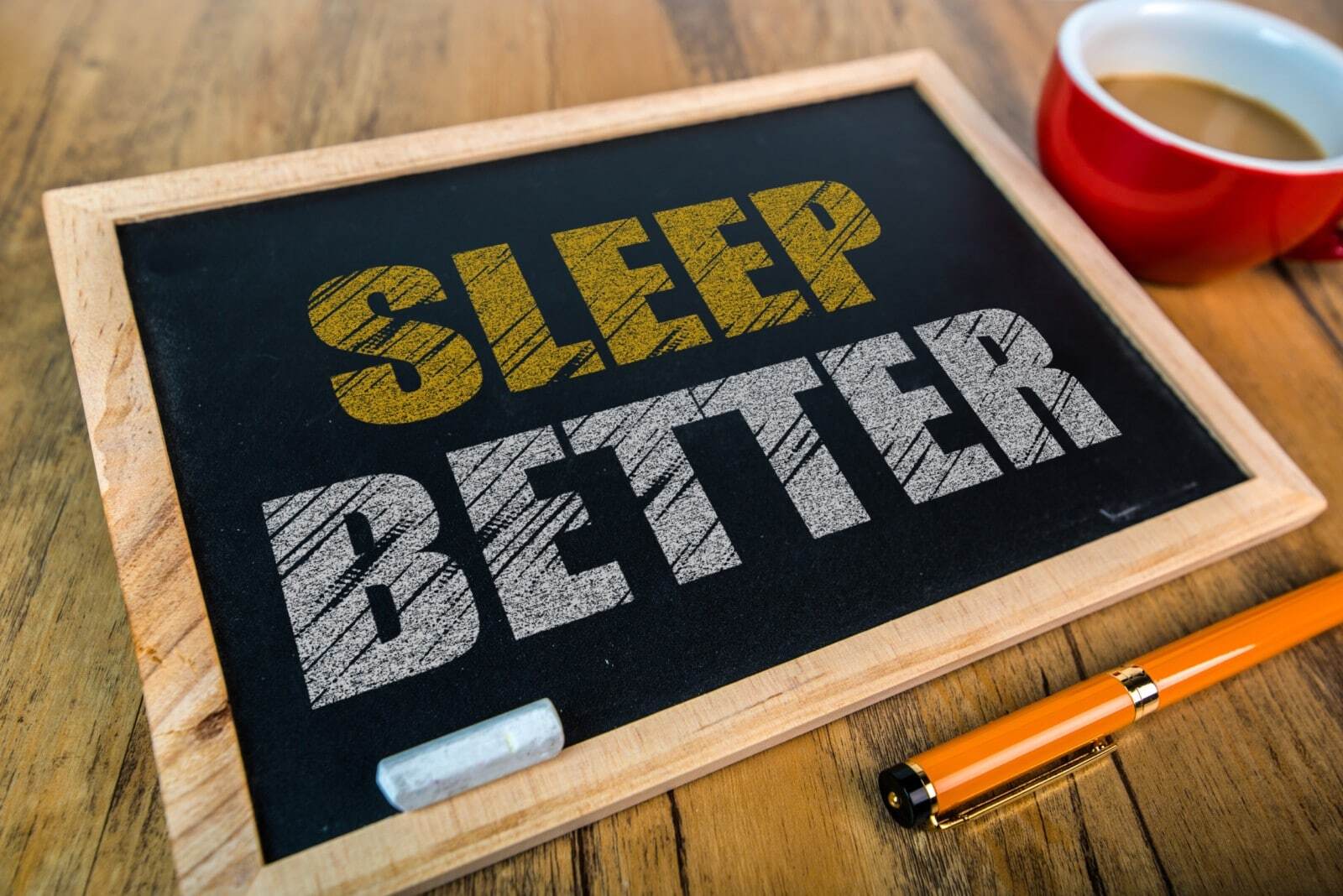 Black board with "sleep better" written on it.