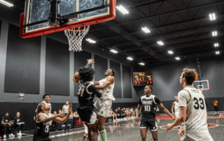 A basketball player goes for an interior shot with a basketball.