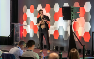 Jess Elis speaking at the Huddle 2025