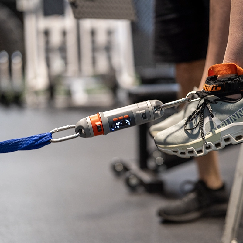 An athlete jumping with a DynaMo guage hooked up to their ankle.