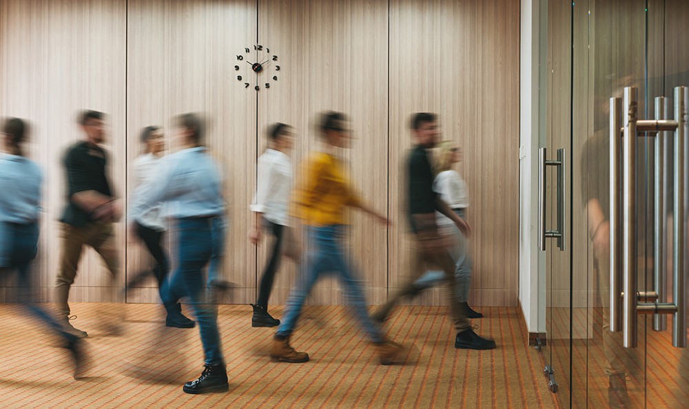 Long exposure of people entering an office.