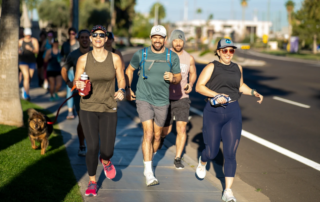A group of people running along a street.