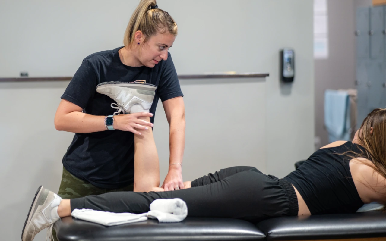 Kim Wolf-King working on the leg of a dancer.