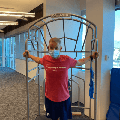 A man demonstrating a Door chest stretch.