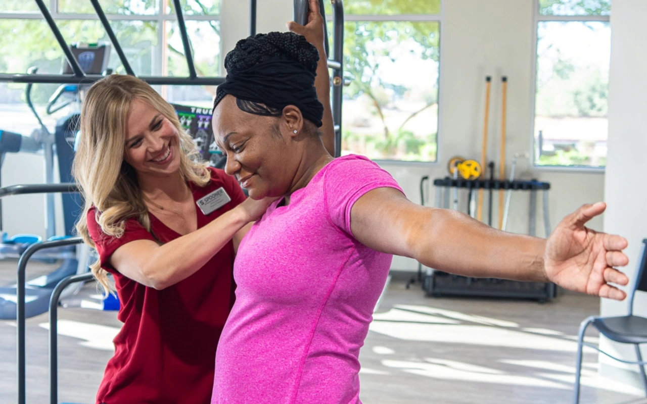 Feature image of a woman stretching with the help of a breast health specialist.