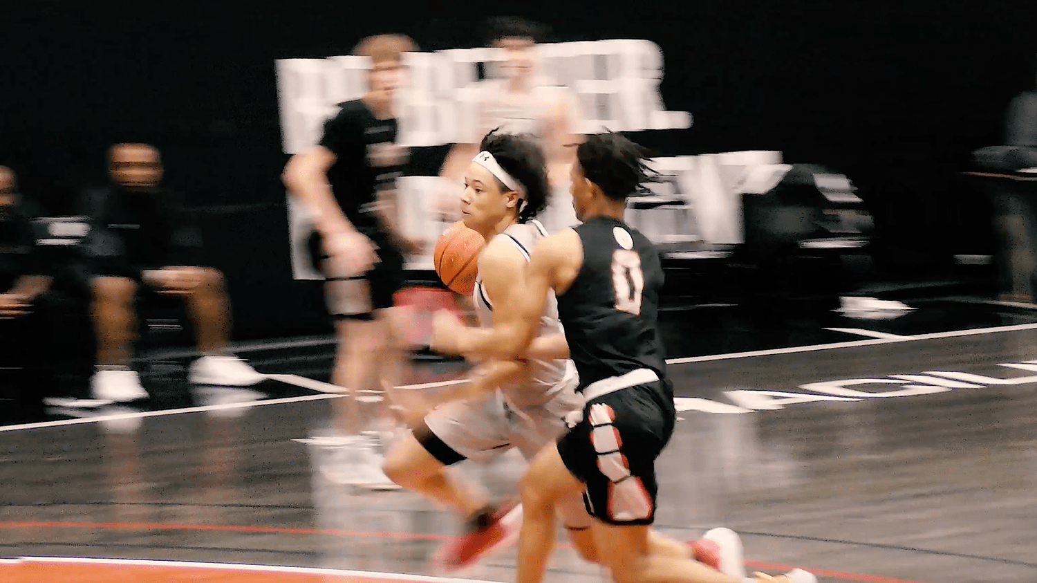 Two basketball players on the court.