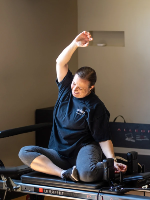 a woman doing an overhead stretch.