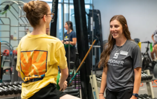 Feature Image of Mckenna working with a young athlete.