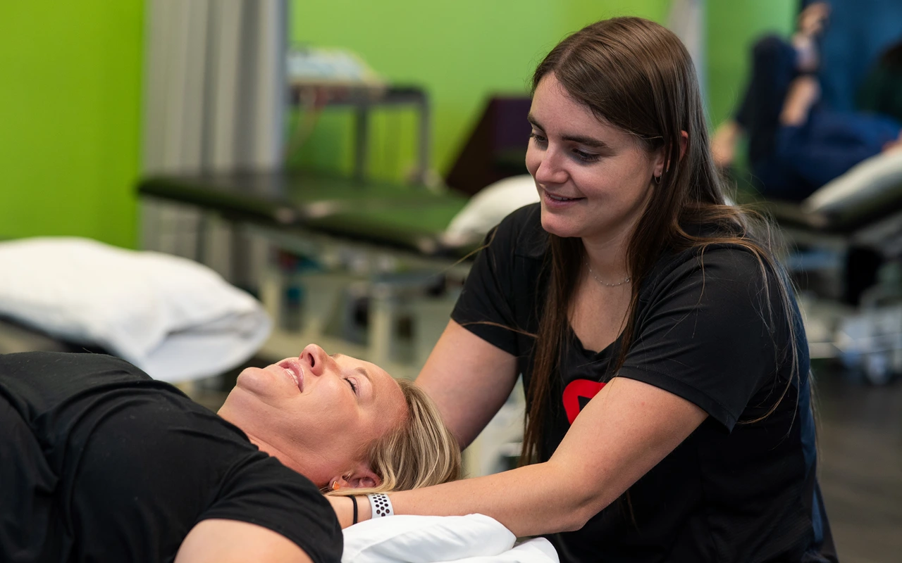 Alix Ungaretti, PT, DPT doing neck manipulation on a female patient.