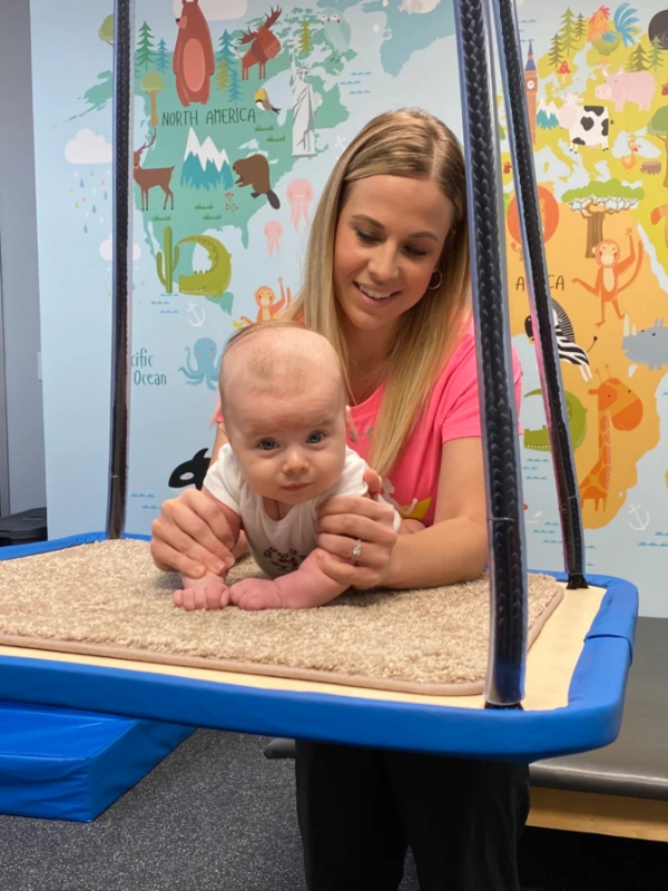 Image of a baby on a tummy swing.