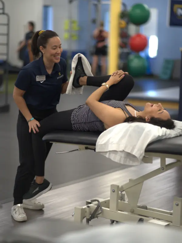 Pelvic Health Image 5 Image of a woman laying on a table with her arms and legs in the air.