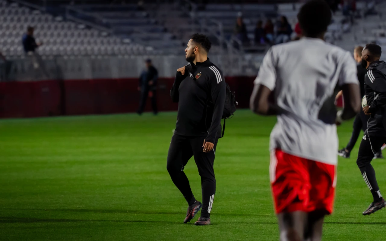Rafael and a soccer player on a soccer field.