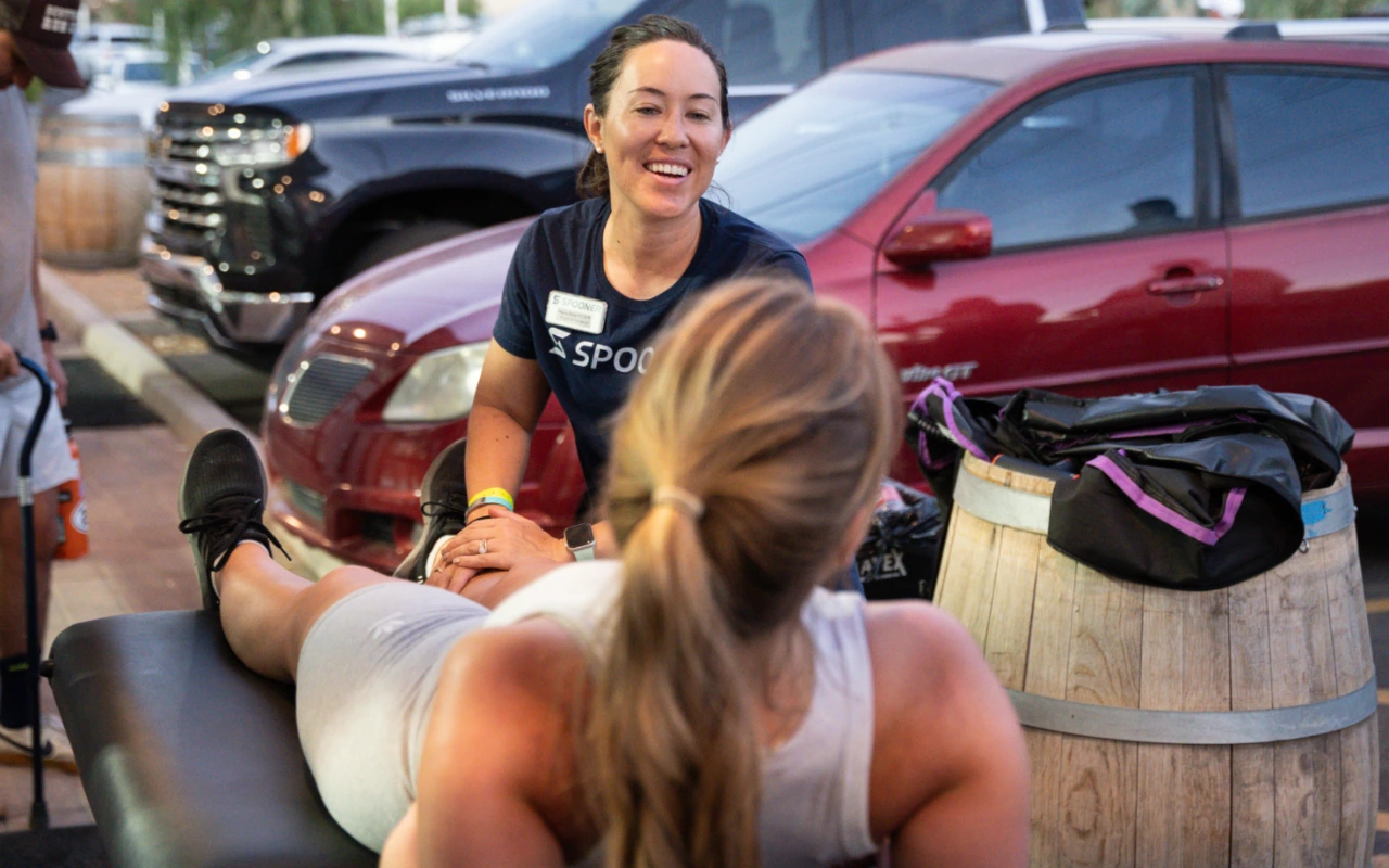 Maria Kline treating a runner just before a marathon.