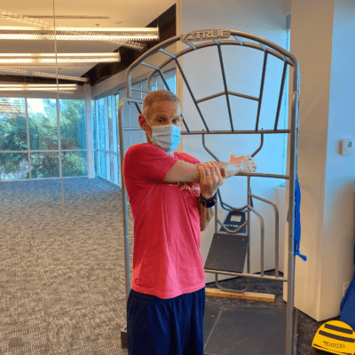 A man demonstrating Upper arm stretch.