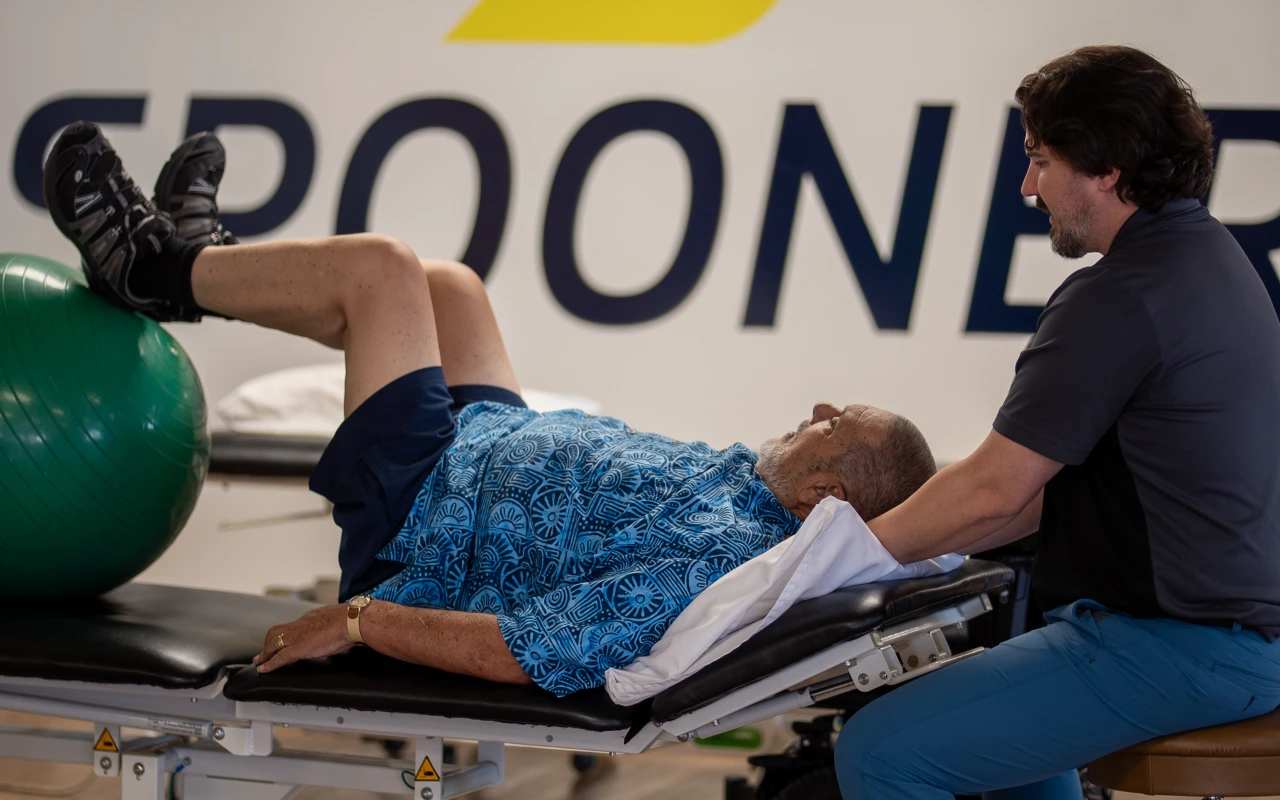 A therapist helping a patient as they do exercises.