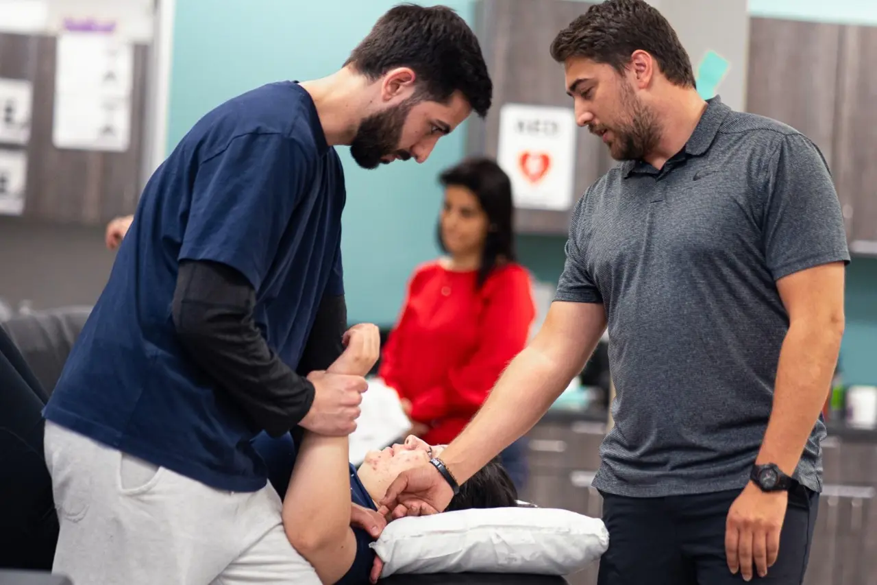 Student LP Image 5 A therapist doing hands on training with a PT student.