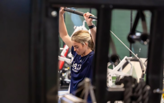 Alix Ungaretti using a squat rack.