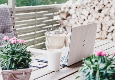 A laptop on a table outside.