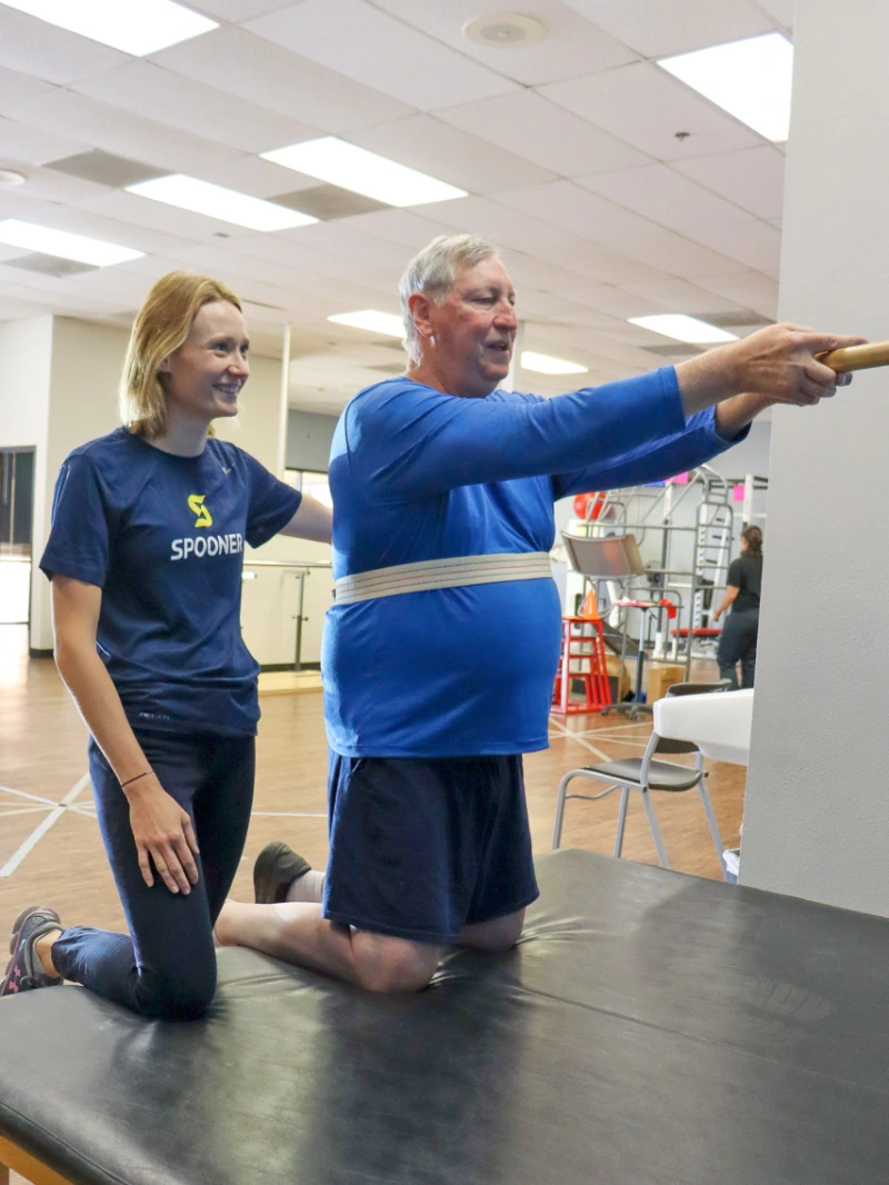 Image of a therapist treating patient with Parkinson's.