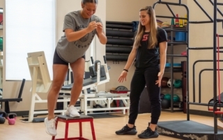 Feature image of a female athlete balancing on one foot on a blue balance pad.