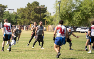 Feature image of a group of men playing flag football.