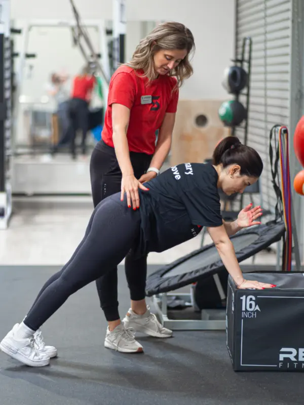 Abby Image Abby Burger stabilizing the back of a patient as they stretch.