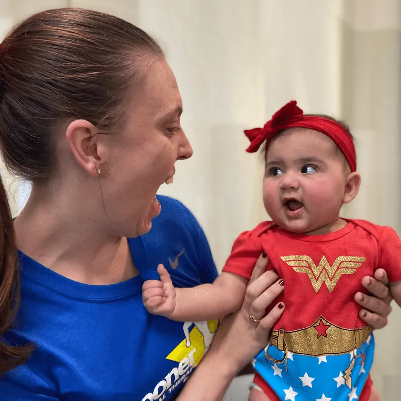 child with torticollis and therapist