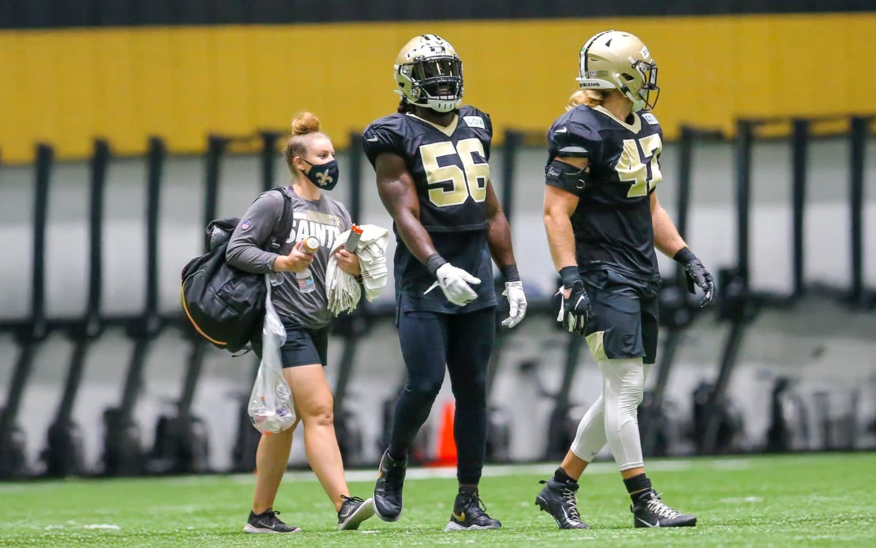 Kaitlyn Keyser on the field with Saints team football players.