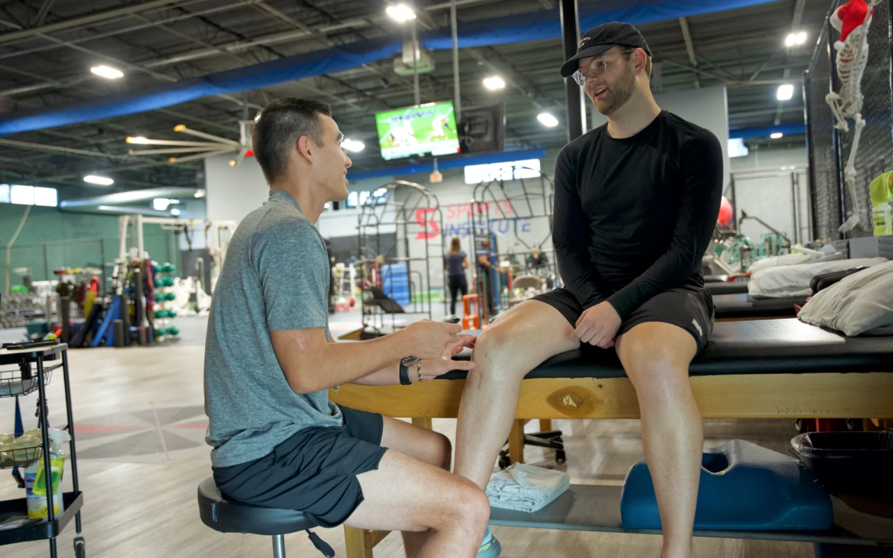 A man being treated for recovery from an ACL surgery.