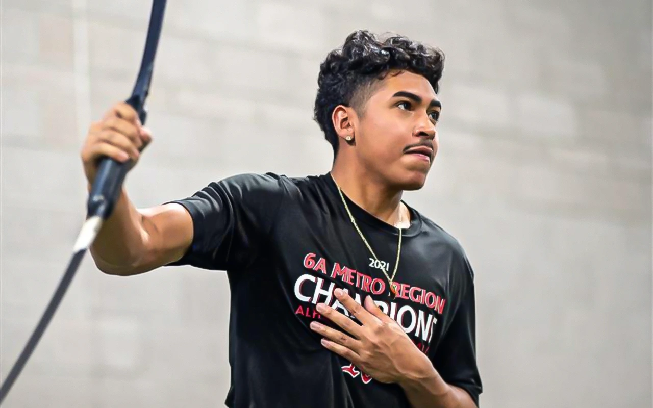 A teen athlete using an elastic bar.