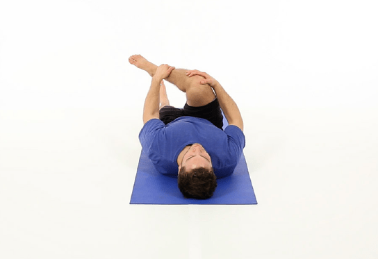 Man performs PIRIFORMIS STRETCH.