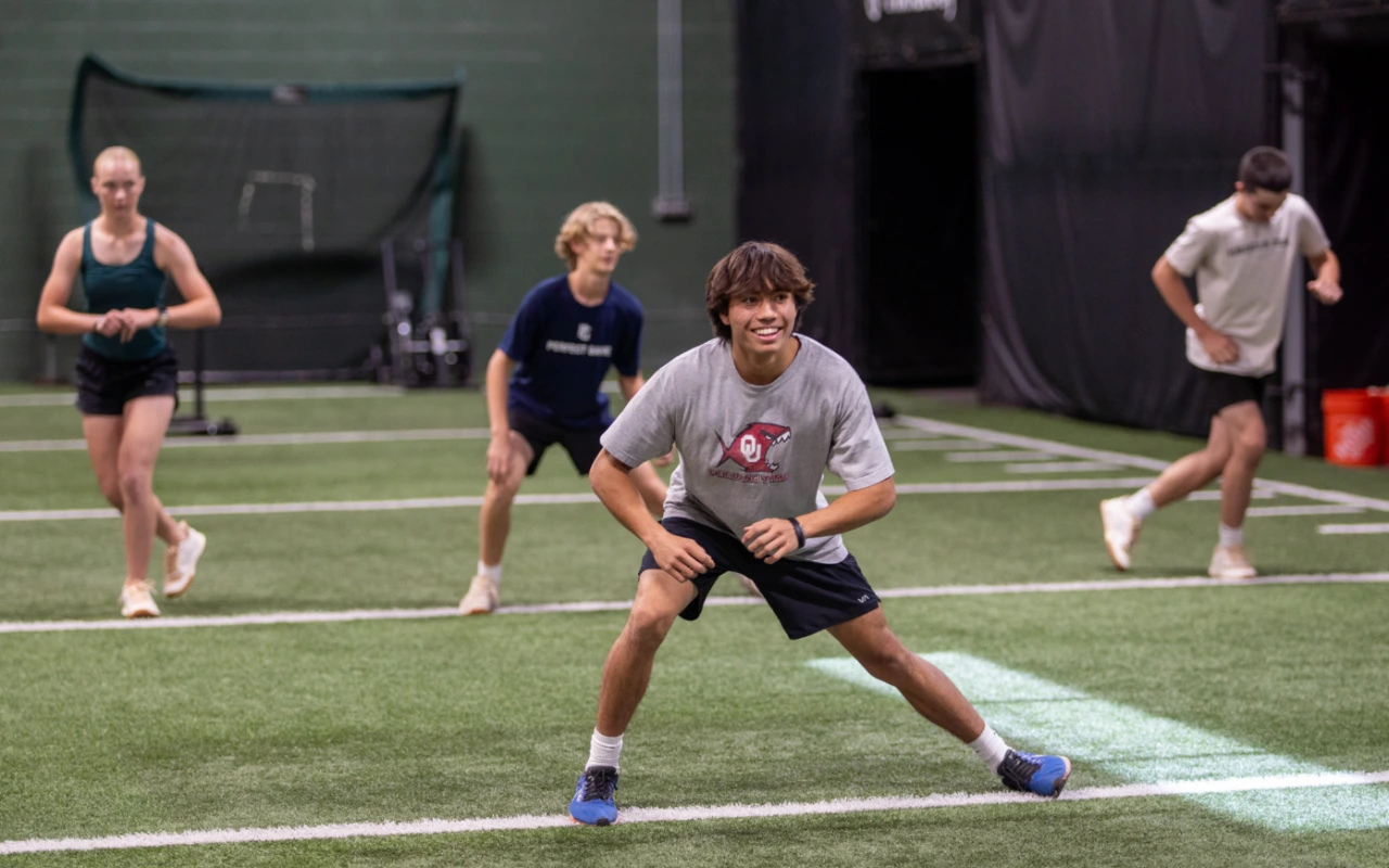 A group a teen training on an indoor turf.