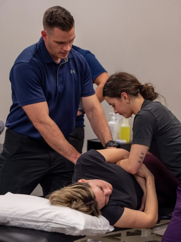 A therapist teaching some physical therapy students.