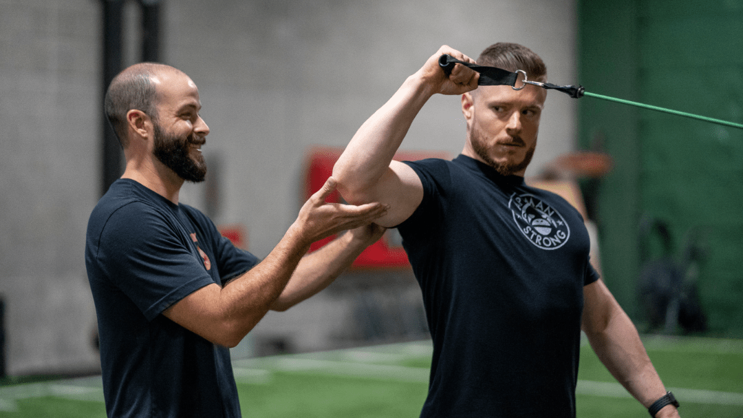 Image of Tanner Chitwood helping a crossbow athlete with shoulder rotation