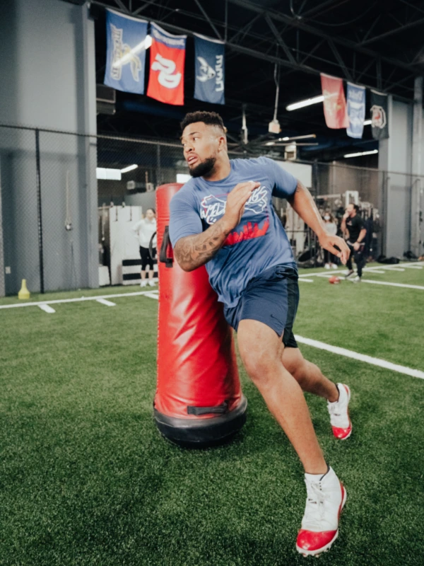 Image of a football player dodging an obstacle.