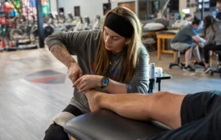 A therapist working on the foot of a patient.