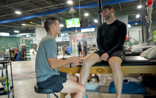 A man being treated for recovery from an ACL surgery.