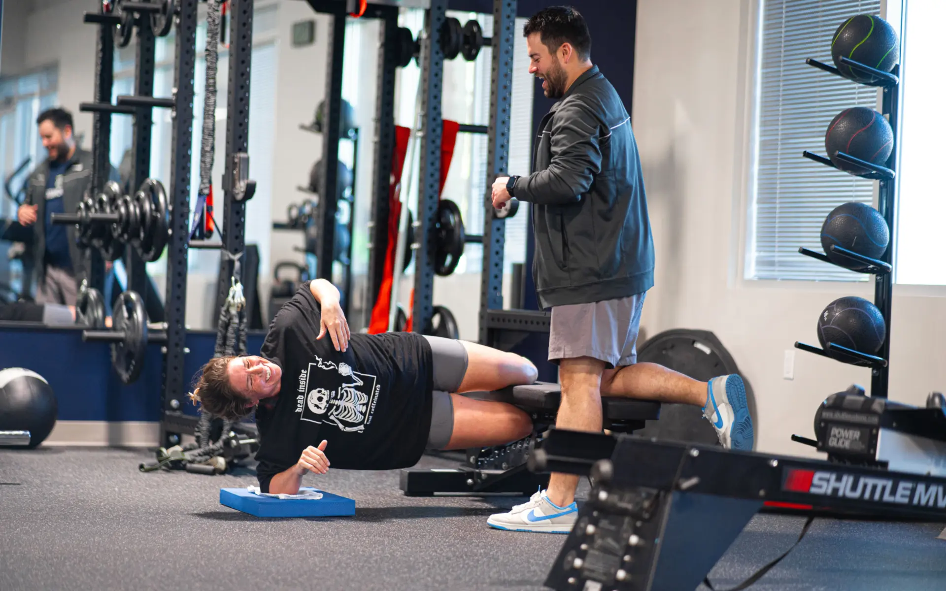 Parker Hirsch, PT, DPT, FAS with a female patient as she does a later plank.