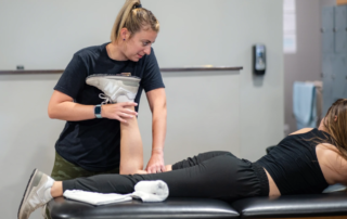 Kim Wolf-King working on the leg of a dancer.