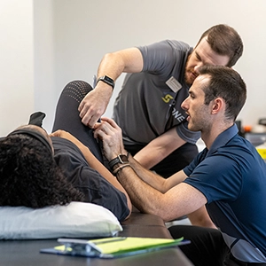 clinic director teaching a physical therapy student