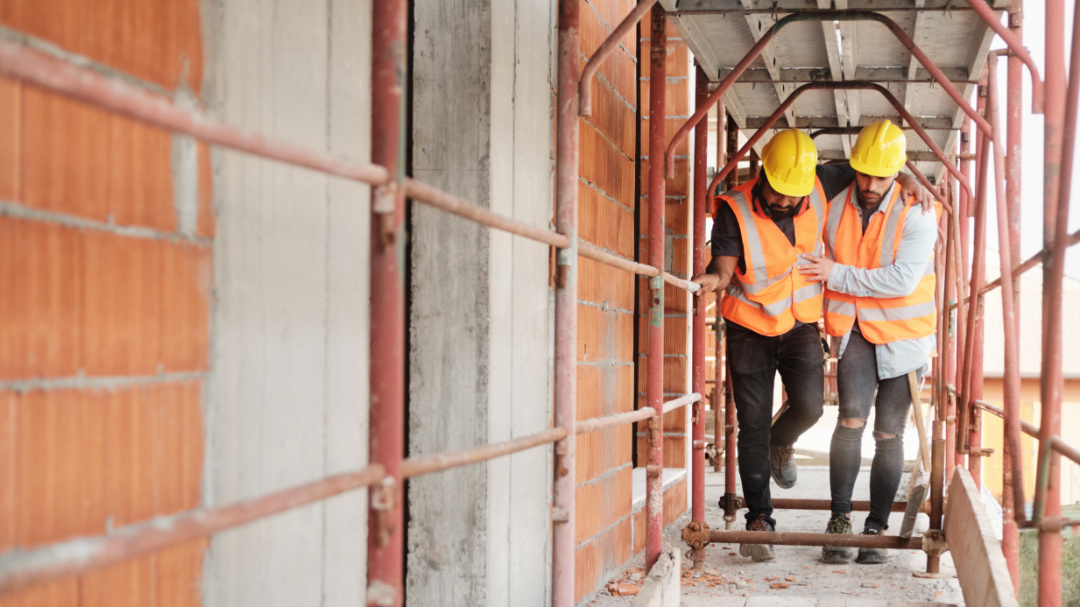 construction worker heling injured coworker