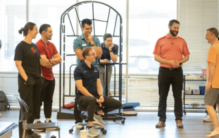 A group of physical therapists in a training session.